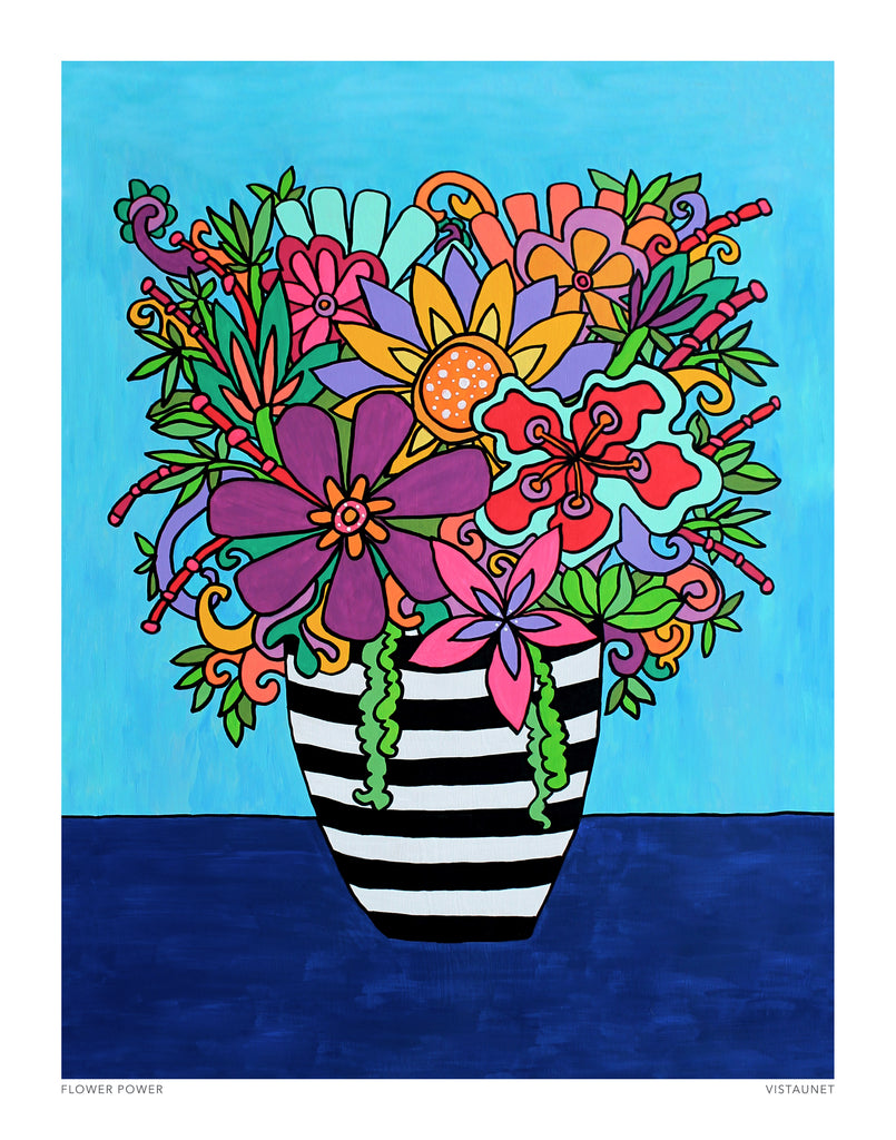 black and white striped vase filled with colorful flowers in bright pinks, purples, oranges, and greens against a turquoise background and a dark blue table.
