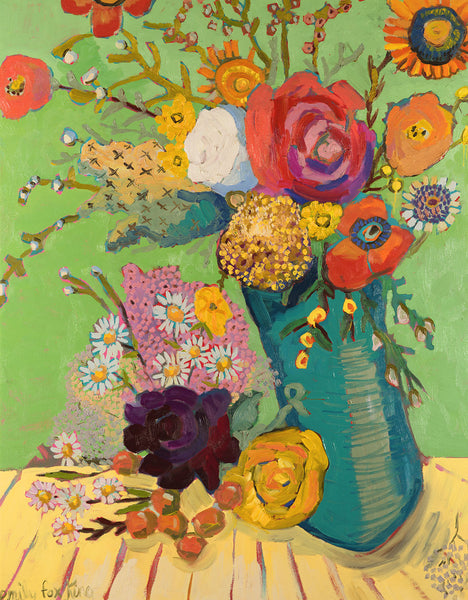 A dark turquoise vase filled with orange, pink, mustard, red and white flowers against a dark spring green wall and on a yellow cloth with red stripes.